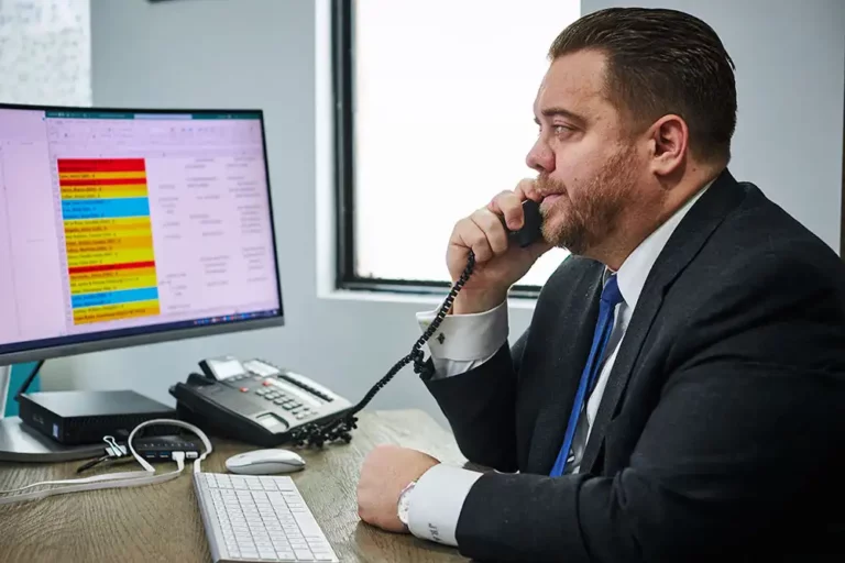 Attorney reviewing a car accident case while speaking with a client