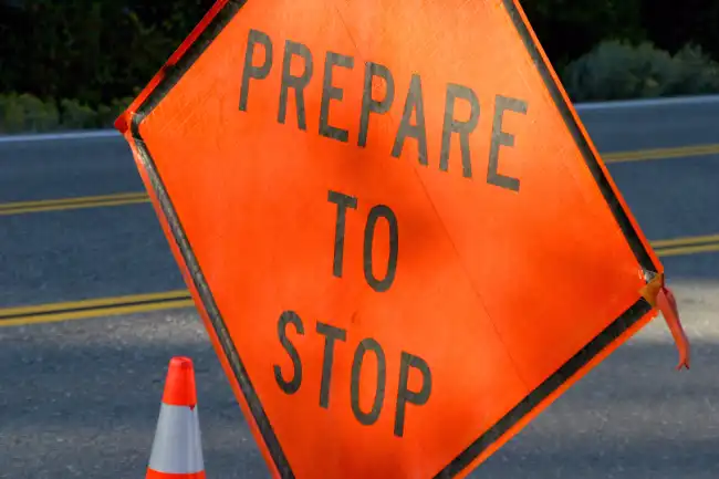 Bike accident risk near road with prepare to stop sign warning ahead