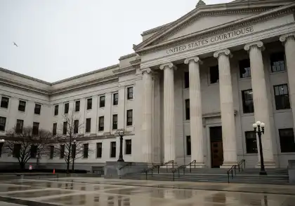 Exterior of a United States courthouse building on a rainy day during government shutdown operations