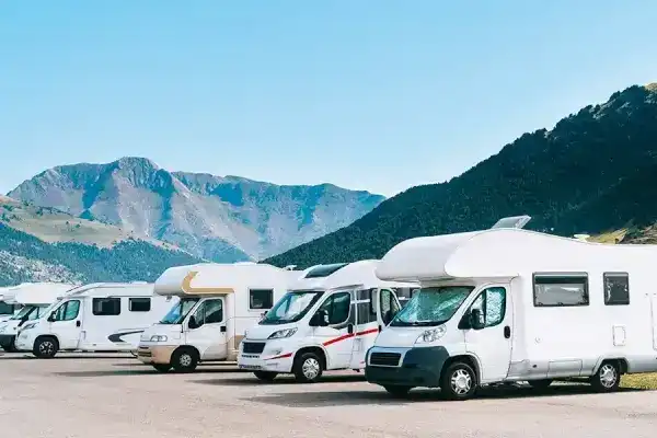 Fila de vehículos recreativos estacionados que reflejan riesgos potenciales de accidentes