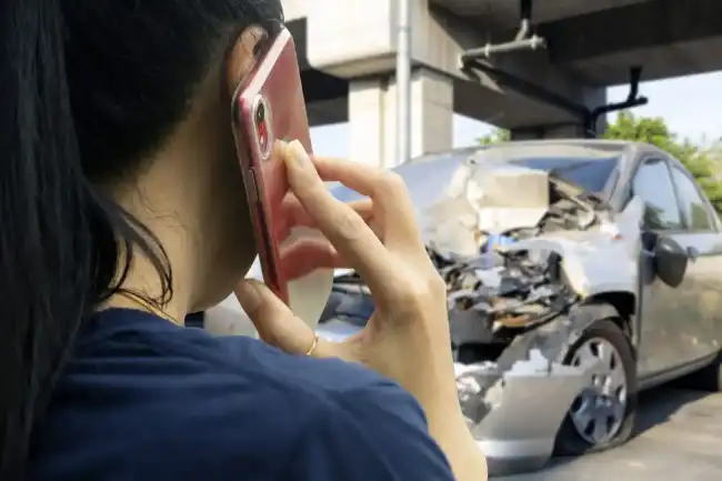 Woman calling her lawyer after being involved in a car accident