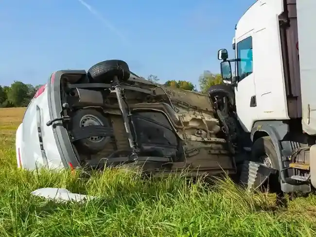 Truck accident scene showing car collided with truck