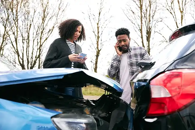 Two drivers are conversing about the damage to their cars after an accident in Contra Costa.