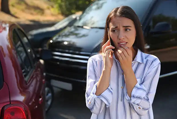 Woman calling a lawyer after a car accident