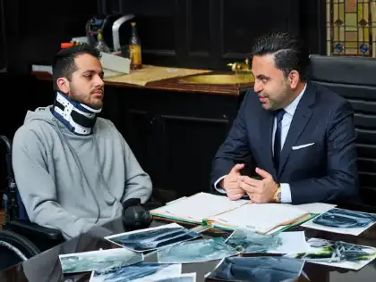 Injured accident victim meeting with a lawyer to pursue a personal injury lawsuit