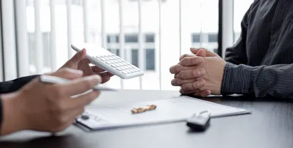 Attorney showing financial details of a car accident claim to a client