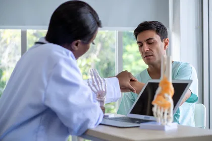 Car accident victim consulting with a doctor about a wrist injury