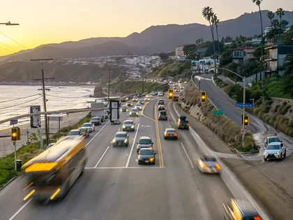 Coastal highway traffic demonstrating safe following distance and defensive driving techniques