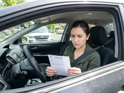 Driver reviewing a traffic ticket to challenge an unusual law