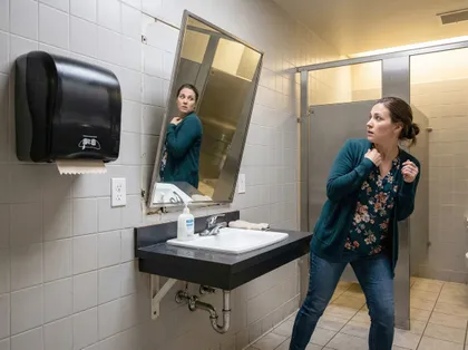 Public restroom accident caused by a falling mirror fixture