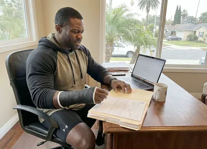 Injured gym member reviewing compensation claim documents