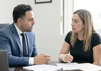 Lawyer discussing rental cost liability with injured crash victim