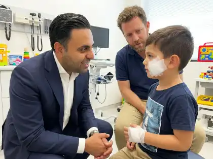 Attorney talking with injured child in exam room