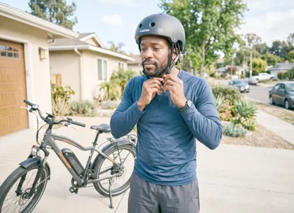 California e-bike rider wearing a safety helmet