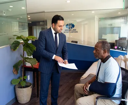 Personal injury law firm meeting with attorney advising injured client about legal rights and claim process