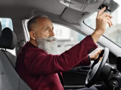 Un hombre mayor al volante de un coche