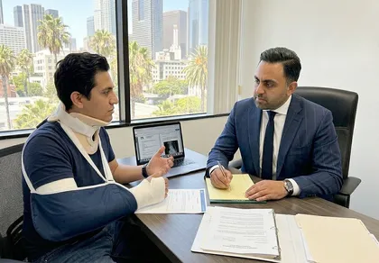 Personal injury attorney meeting with Rialto client to review medical records and police report