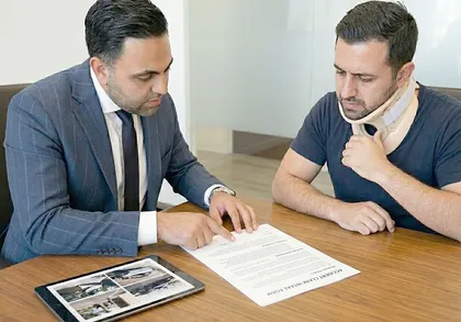 víctima de accidente lesionada revisa con un abogado su reclamación por culpa comparativa
