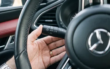 Driver reaching for the turn signal to prevent a traffic accident