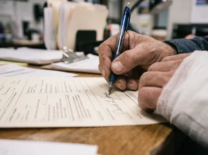 Dog bite victim completing legal claim documents and signing forms