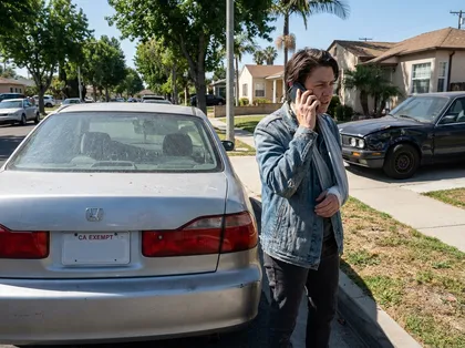 Injured driver speaking with an insurance adjuster after a car accident