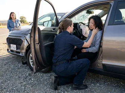 Paramedic treats an injured passenger after a California car accident