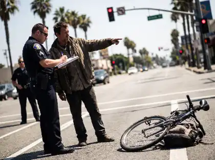 Police officer interviewing witness after bicycle accident