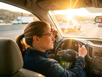 Un conductor tiene dificultades para ver debido al resplandor del sol en una autopista muy transitada