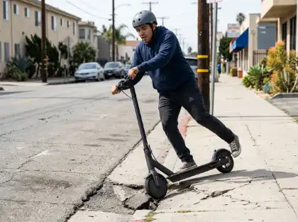 E-scooter rider losing balance on cracked sidewalk during urban ride