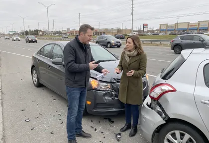 Uninsured driver crash victims reviewing vehicle damage and insurance options after a collision